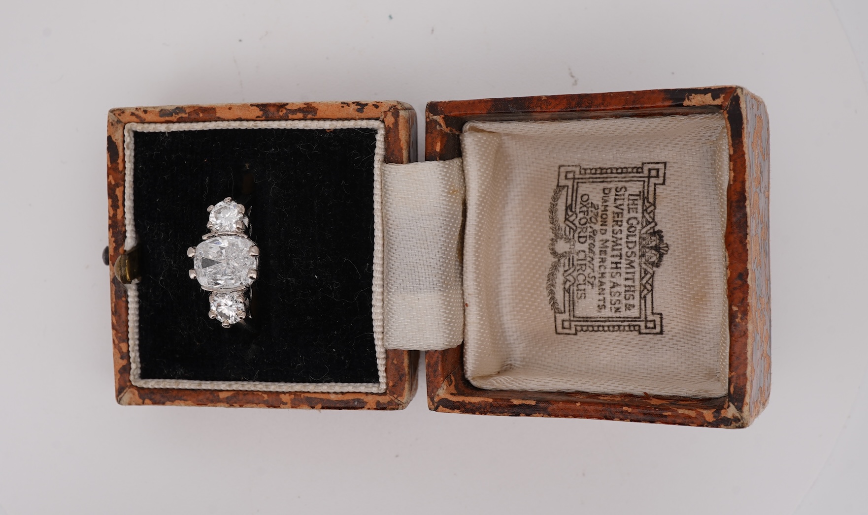 A diamond ring, set with a cushion-shaped diamond weighing 1.50 carats, between shoulders set with brilliant-cut diamonds totalling approximately 0.40 carats, size K, gross weight approximately 4 grams, Condition: centra